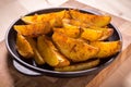 Baked sliced potatoes on pan