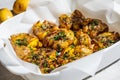 Baked smashed potatoes with herbs in white oven dish Royalty Free Stock Photo