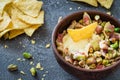 Baked soft cheese brie with figs, walnuts, pistachios and honey in a bowl