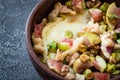 Baked soft cheese brie with figs, walnuts, pistachios and honey in a bowl