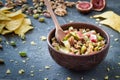 Baked soft cheese brie with figs, walnuts, pistachios and honey in a bowl