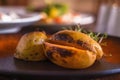 Baked spicy potatoes on plate, close up. Selective focus