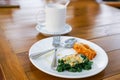 Baked Spinach with Cheese and deep fried chicken on white ceramic plate Royalty Free Stock Photo
