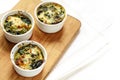 Baked spinach with cheese in three small casserole dishes on a