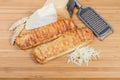 Cheese-stuffed flaky pastry sticks, different cheese, grater, wheat ears