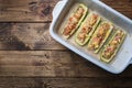 Baked stuffed zucchini boats with minced chicken mushrooms and vegetables with cheese on a baking sheet. Top view Copy space Royalty Free Stock Photo