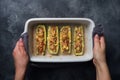 Baked stuffed zucchini boats with minced chicken mushrooms and vegetables with cheese on a baking sheet. Top view Copy space Royalty Free Stock Photo