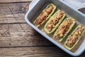Baked stuffed zucchini boats with minced chicken mushrooms and vegetables with cheese on a baking sheet. Top view Copy space Royalty Free Stock Photo
