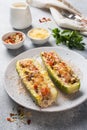 Baked stuffed zucchini boats with minced chicken mushrooms and vegetables with cheese on a plate Royalty Free Stock Photo