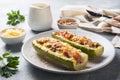 Baked stuffed zucchini boats with minced chicken mushrooms and vegetables with cheese on a plate Royalty Free Stock Photo