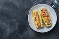 Baked stuffed zucchini boats with minced chicken mushrooms and vegetables with cheese on a plate. Copy space Royalty Free Stock Photo