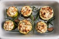 Baked stuffed zucchini columns with minced chicken and vegetables in a ceramic baking dish. Royalty Free Stock Photo