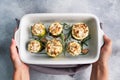 Baked stuffed zucchini columns with minced chicken and vegetables in a ceramic baking dish. Royalty Free Stock Photo