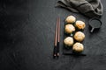 Baked sushi maki rolls with salmon, crab, cucumber, avocado, flying fish roe and spicy sauce, on black stone background , with Royalty Free Stock Photo