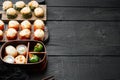 Baked sushi maki rolls with salmon, crab, cucumber, avocado, flying fish roe and spicy sauce, on black wooden table background , Royalty Free Stock Photo