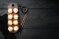 Baked sushi maki rolls with salmon, crab, cucumber, avocado, flying fish roe and spicy sauce, on black wooden table background, Royalty Free Stock Photo