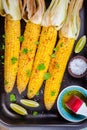 Baked sweet corn cobs with herb butter and lime Royalty Free Stock Photo