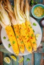 Baked sweet corn cobs with herb butter and lime Royalty Free Stock Photo