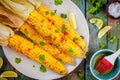 Baked sweet corn cobs with herb butter and lime Royalty Free Stock Photo