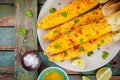 Baked sweet corn cobs with herb butter and lime Royalty Free Stock Photo