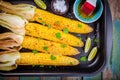 Baked sweet corn cobs with herb butter and lime Royalty Free Stock Photo