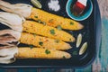 Baked sweet corn cobs with herb butter and lime Royalty Free Stock Photo