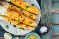 Baked sweet corn cobs with herb butter and lime Royalty Free Stock Photo