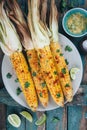 Baked sweet corn cobs with herb butter and lime Royalty Free Stock Photo