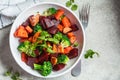 Baked sweet potato, beetroot and broccoli salad in white bowl, top view Royalty Free Stock Photo