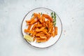 Baked sweet potato fries with lime and herbs on plate. top view Royalty Free Stock Photo