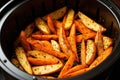 Baked sweet potato wedges with herbs and spices in the oven, Cooking potatoes and carrot sticks with spices in an air fryer, AI