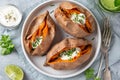 Baked sweet potato with yogurt sause and chives Royalty Free Stock Photo