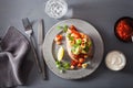 Baked sweet potatoes with avocado chili salsa and beans