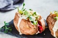 Baked sweet potatoes stuffed with quinoa, vegetables and tahini, top view. Baked vegetables, vegan food concept Royalty Free Stock Photo