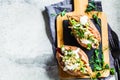 Baked sweet potatoes stuffed with quinoa, vegetables and tahini, top view. Baked vegetables, vegan food concept Royalty Free Stock Photo