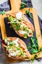 Baked sweet potatoes stuffed with quinoa, vegetables and tahini, top view. Baked vegetables, vegan food concept Royalty Free Stock Photo