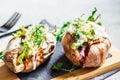 Baked sweet potatoes stuffed with quinoa, vegetables and tahini. Baked vegetables, vegan food concept Royalty Free Stock Photo