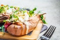 Baked sweet potatoes stuffed with quinoa, vegetables and tahini. Baked vegetables, vegan food concept Royalty Free Stock Photo