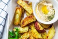 Baked sweet potatoes in white oven dish with hummus. Vegan food concept