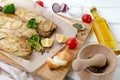 Baked tasty mackerel fish with lemon, sliced on filet with tomatoes, onion rings, pepper, herbs, olive oil and broccoli Royalty Free Stock Photo