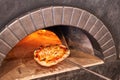 Baked tasty margherita pizza in Traditional wood oven in Naples restaurant, Italy. Original neapolitan pizza. Red hot Royalty Free Stock Photo