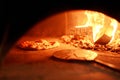 Baked tasty margherita pizza in Traditional wood oven in Naples restaurant, Italy. Original neapolitan pizza. Red hot Royalty Free Stock Photo