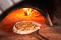 Baked tasty margherita pizza in Traditional wood oven in Naples restaurant, Italy. Original neapolitan pizza. Red hot Royalty Free Stock Photo