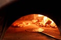 Baked tasty margherita pizza in Traditional wood oven in Naples restaurant, Italy. Original neapolitan pizza. Red hot Royalty Free Stock Photo