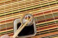 Baked tempura breaded sushi with salmon, hand with chopsticks hold roll on the background of soy sauce Royalty Free Stock Photo