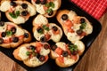 Baked toasts with mozarella, tomatoes, olives and garlic.