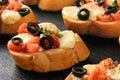 Baked toasts with mozarella, tomatoes, olives and garlic.