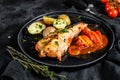Baked in tomatoes monkfish with potatoes and vegetables. Black background. Top view Royalty Free Stock Photo