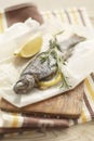 Baked trout in parchment with lemon and rosemary