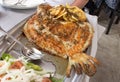 Baked turbot or rodaballo fish on the metal dish in the restaurant Royalty Free Stock Photo